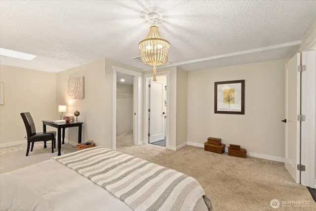 a bedroom with a bed and chandelier