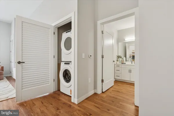 a view of a storage and utility room with wooden floor