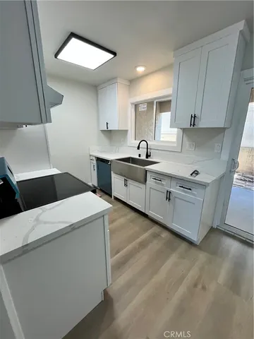 a kitchen that has a sink and a stove in it