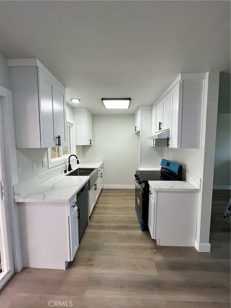 2007 Huntington Lane, Unit 2 Redondo Beach, CA 90278 - Photo 16 of 22 a large kitchen with a lot of counter space and wooden floor