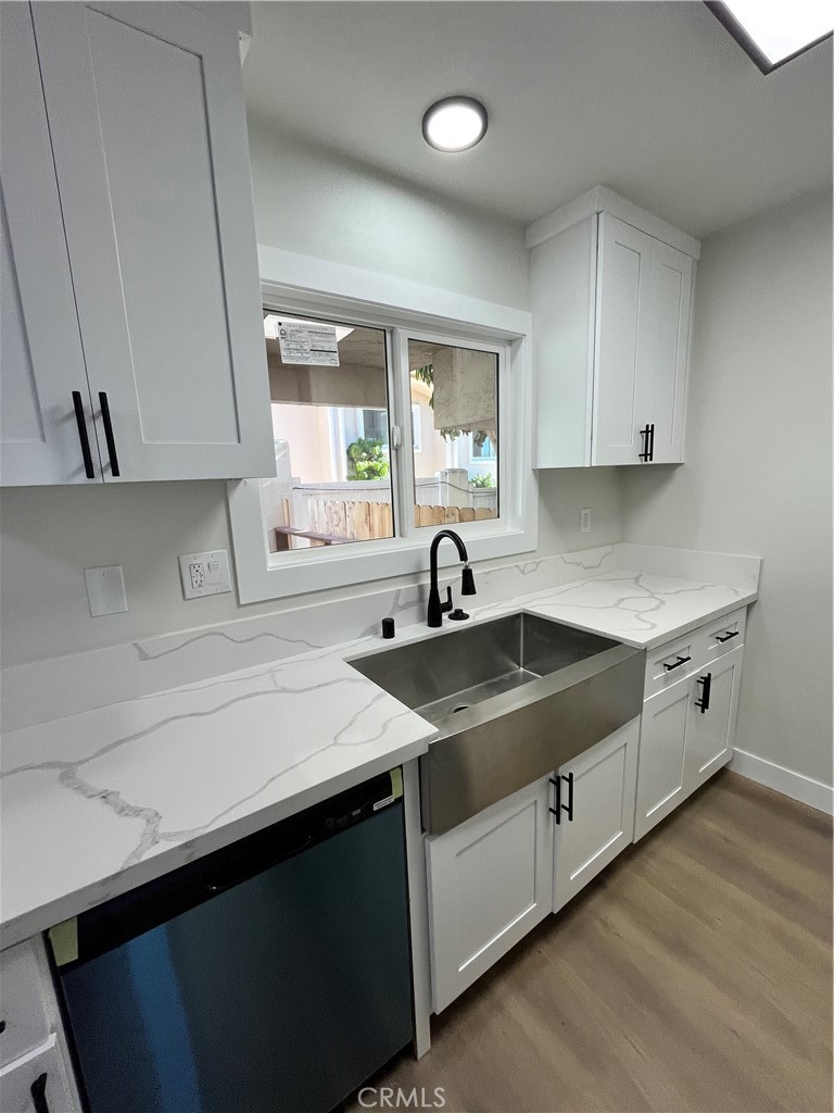 2007 Huntington Lane, Unit 2 Redondo Beach, CA 90278 - Photo 17 of 22 a kitchen with a sink stove and cabinets
