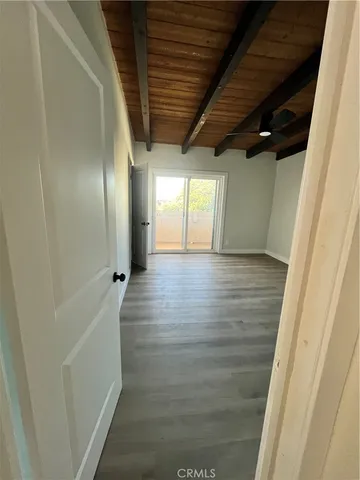 an empty room with wooden floor and closet