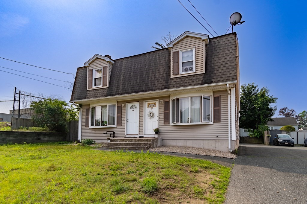 209-211 Verge Street Springfield, MA 01129 - Photo 2 of 14 a front view of a house with garden