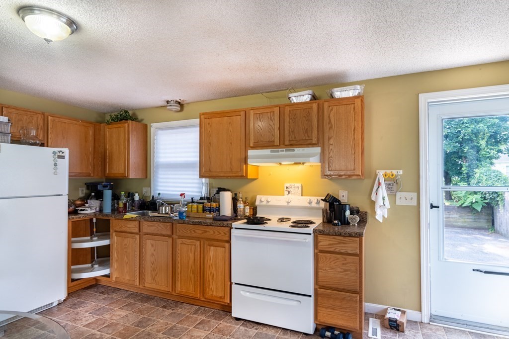 209-211 Verge Street Springfield, MA 01129 - Photo 3 of 14 a kitchen with sink refrigerator and cabinets