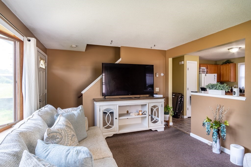 209-211 Verge Street Springfield, MA 01129 - Photo 5 of 14 a living room with furniture and a flat screen tv