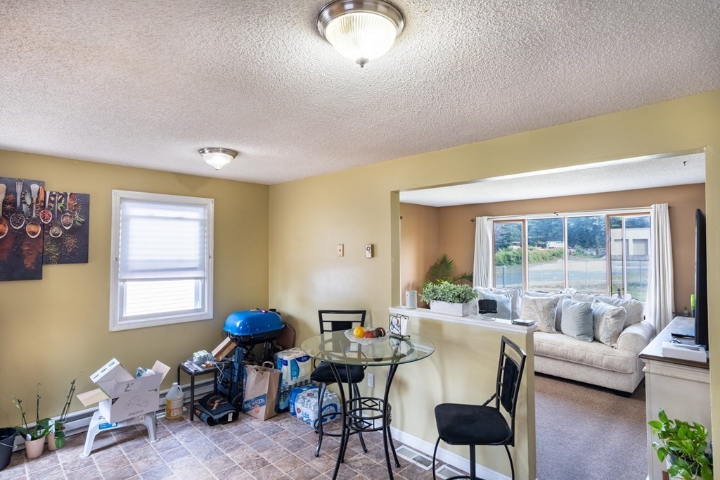 209-211 Verge Street Springfield, MA 01129 - Photo 6 of 14 a living room with furniture and a large window