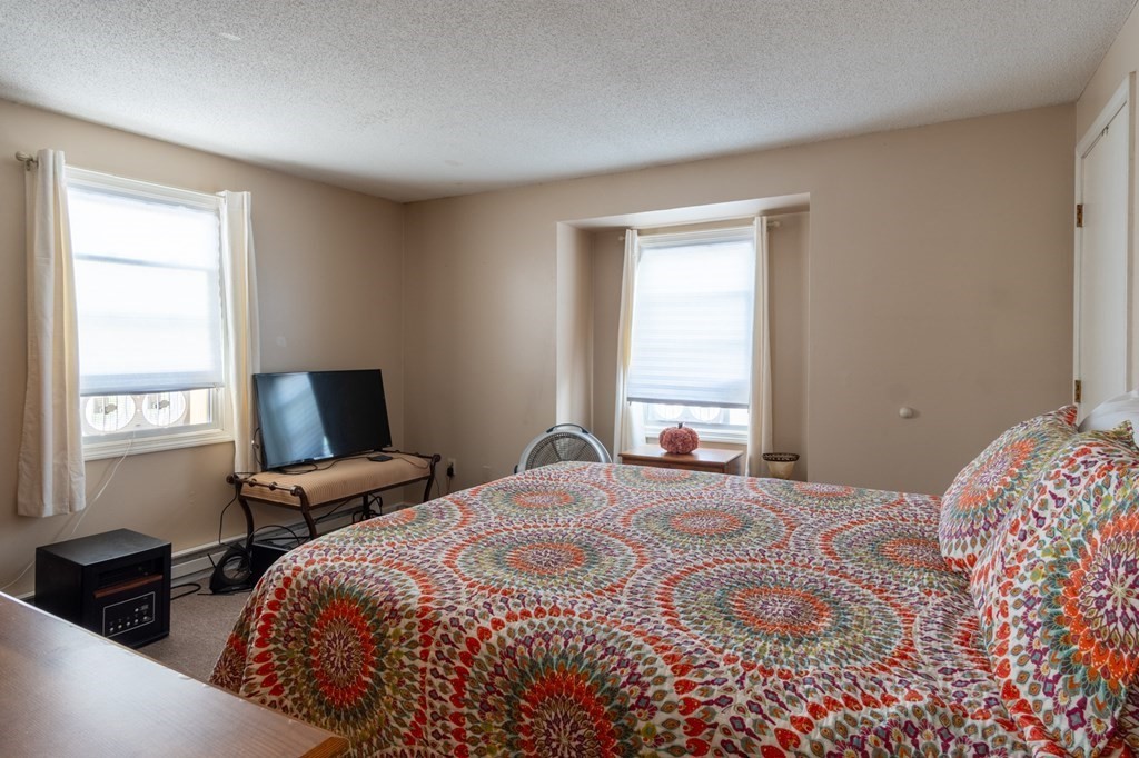 209-211 Verge Street Springfield, MA 01129 - Photo 8 of 14 a bedroom with a bed and a window