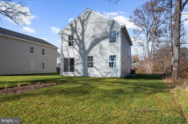 a backyard of apartments with large trees