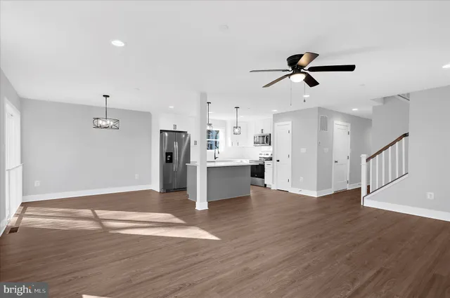 a view of a kitchen with a sink and refrigerator