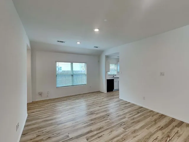 a view of room with wooden floor