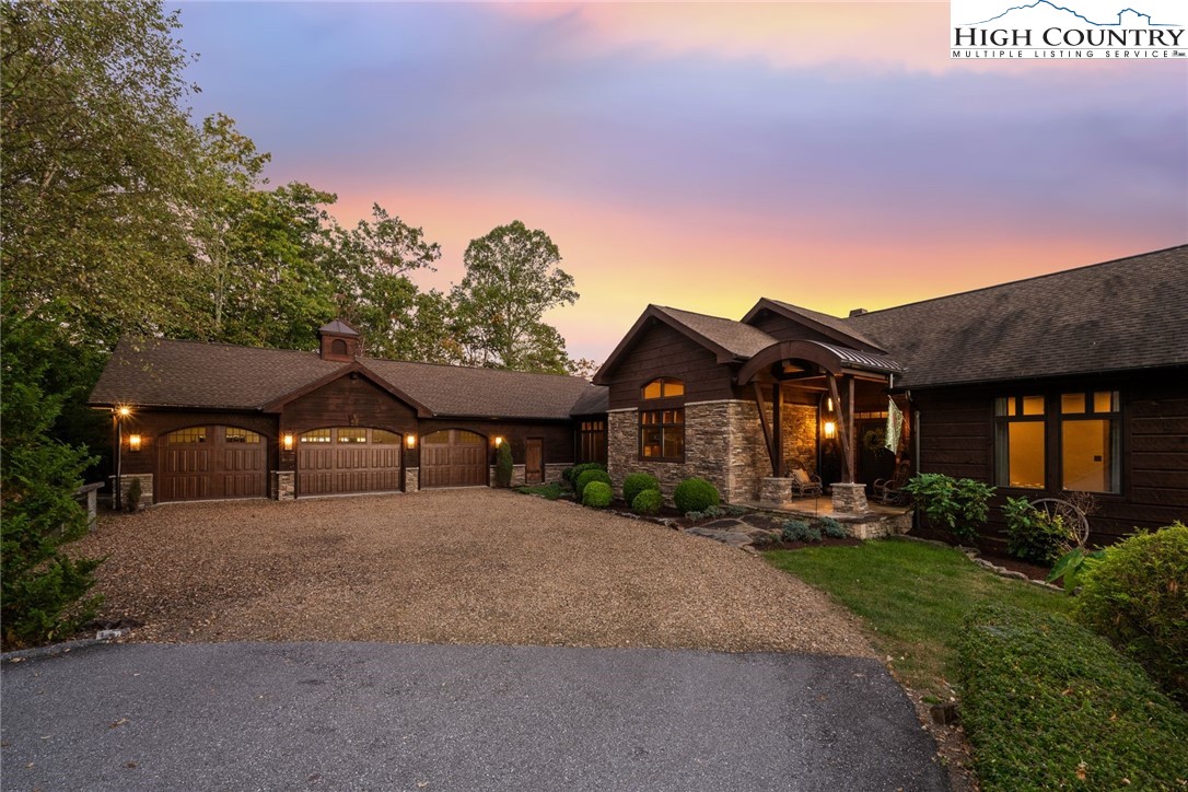 550 Big Sky Road Ferguson, NC 28624 - Photo 1 of 35 a front view of a house with a yard and garage