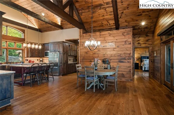 a dining room with furniture and wooden floor