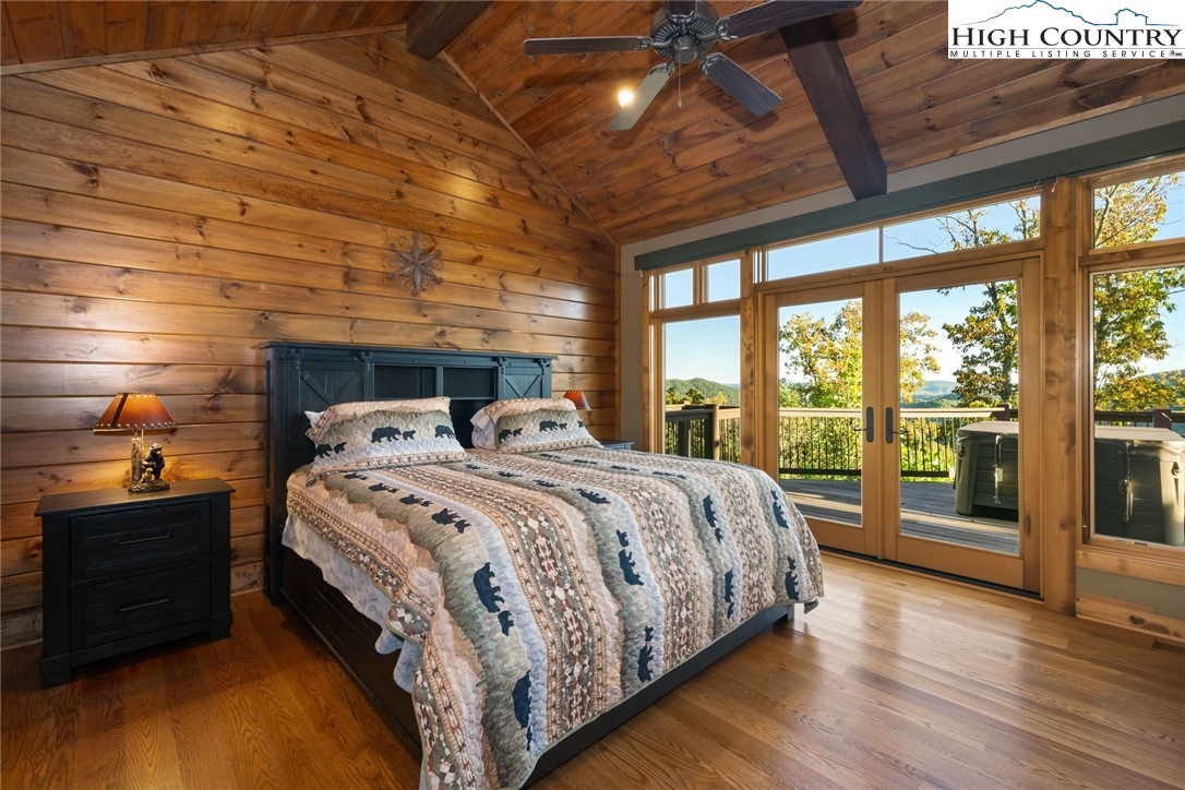 550 Big Sky Road Ferguson, NC 28624 - Photo 18 of 35 a bedroom with a bed and wooden floor