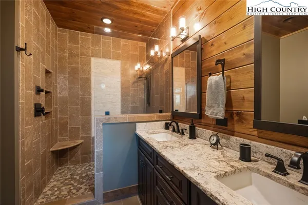 a bathroom with a double vanity sink and a mirror