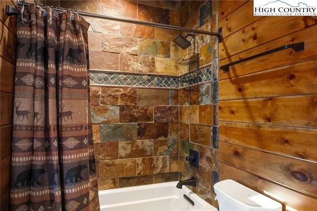 a bathroom with a toilet and shower