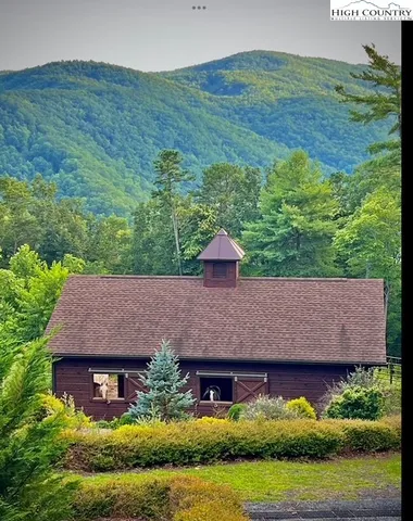 a aerial view of a house with a garden and a yard