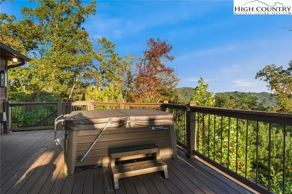 a view of a balcony with wooden floor and outdoor space