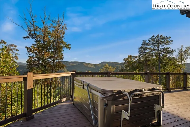 a view of a balcony with wooden floor and outdoor space