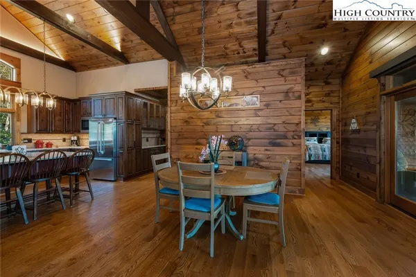a dining room with furniture and wooden floor