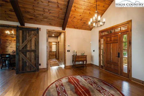 a view of a livingroom with furniture wooden floor and windows