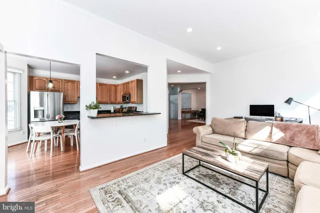 a living room with furniture and kitchen view