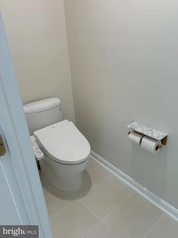 a white toilet sitting next to a white sink