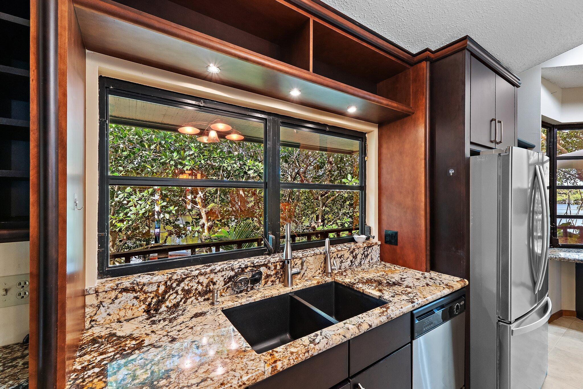 702 Warren Drive Jupiter, FL 33458 - Photo 39 of 76 a kitchen with a sink and large window