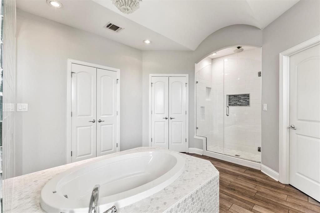 9583 Neal Road Forney, TX 75126 - Photo 14 of 34 a spacious bathroom with a tub shower and mirror