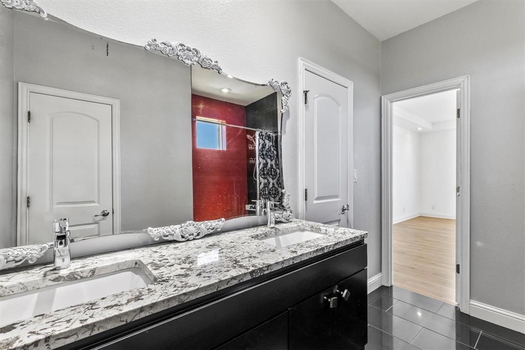9583 Neal Road Forney, TX 75126 - Photo 19 of 34 a bathroom with a granite countertop sink and a mirror
