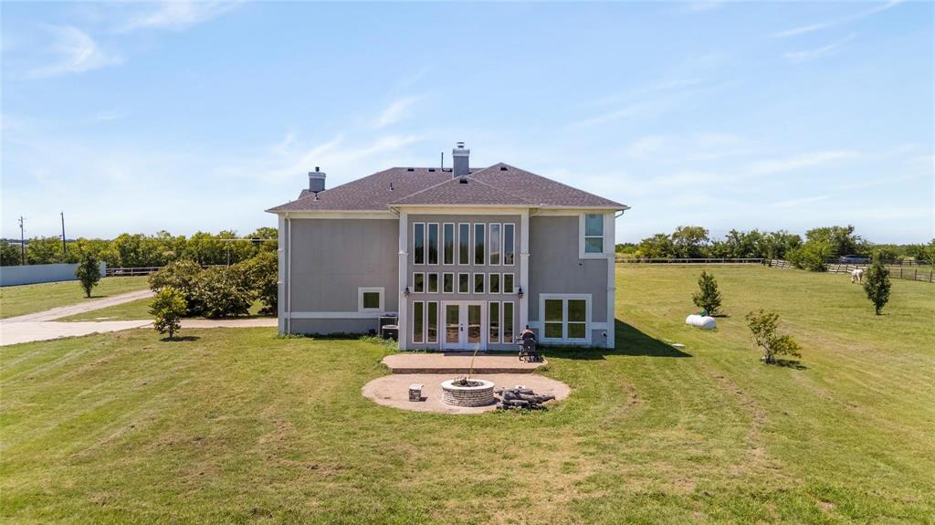 9583 Neal Road Forney, TX 75126 - Photo 2 of 34 a front view of a house with a yard and lake view
