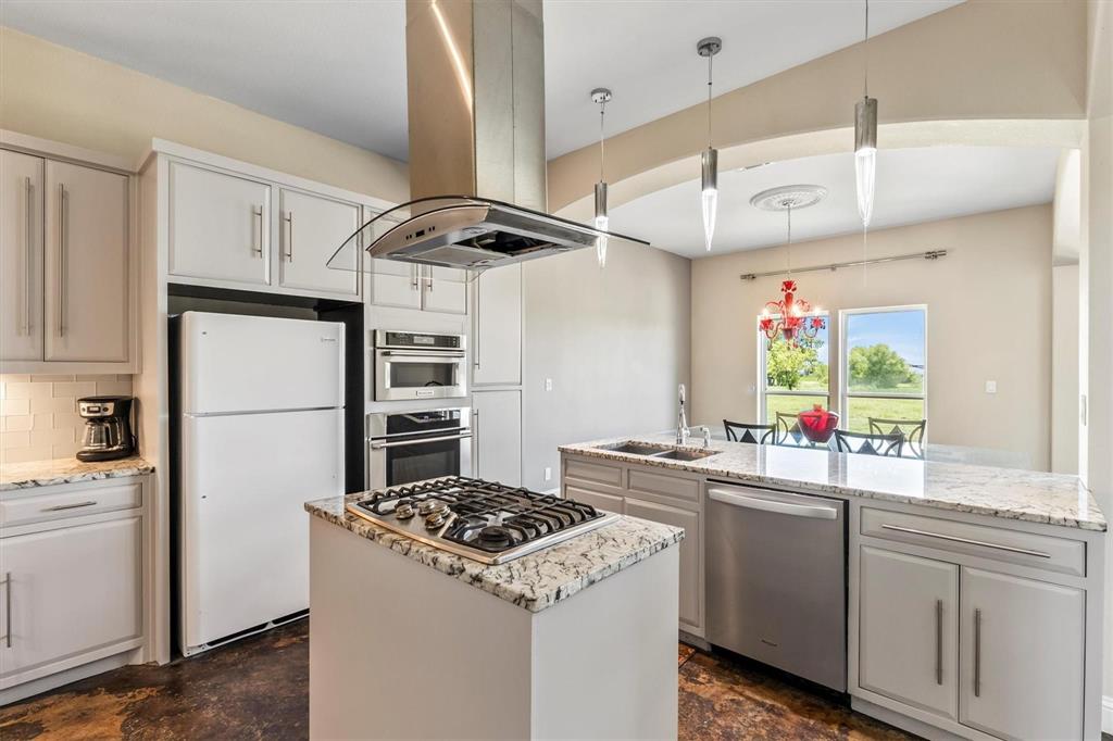 9583 Neal Road Forney, TX 75126 - Photo 8 of 34 a kitchen with a sink stove and refrigerator