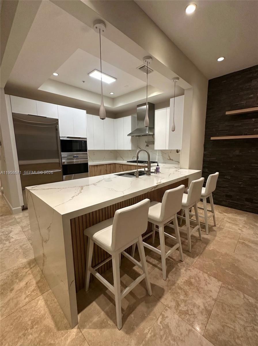 7560 Southwest 56th Court Miami, FL 33143 - Photo 11 of 30 a kitchen with a dining table chairs stainless steel appliances and cabinets