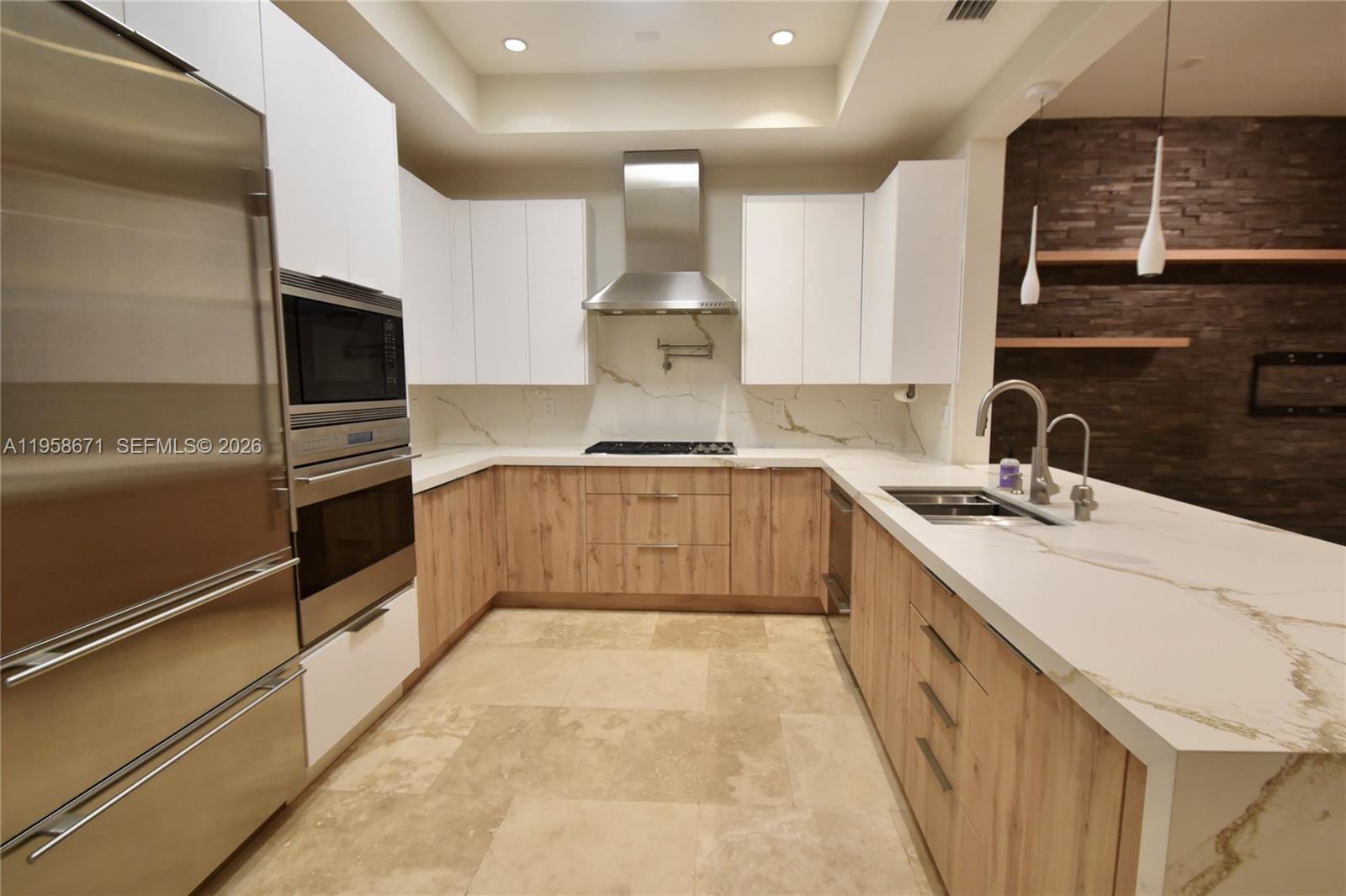 7560 Southwest 56th Court Miami, FL 33143 - Photo 12 of 30 a kitchen with granite countertop a sink stainless steel appliances and cabinets