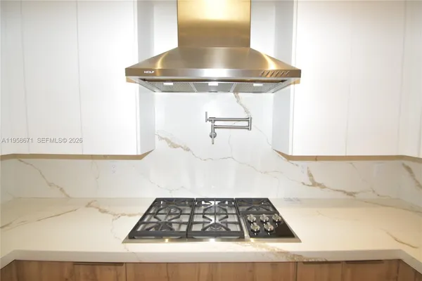 a view of kitchen island with a sink