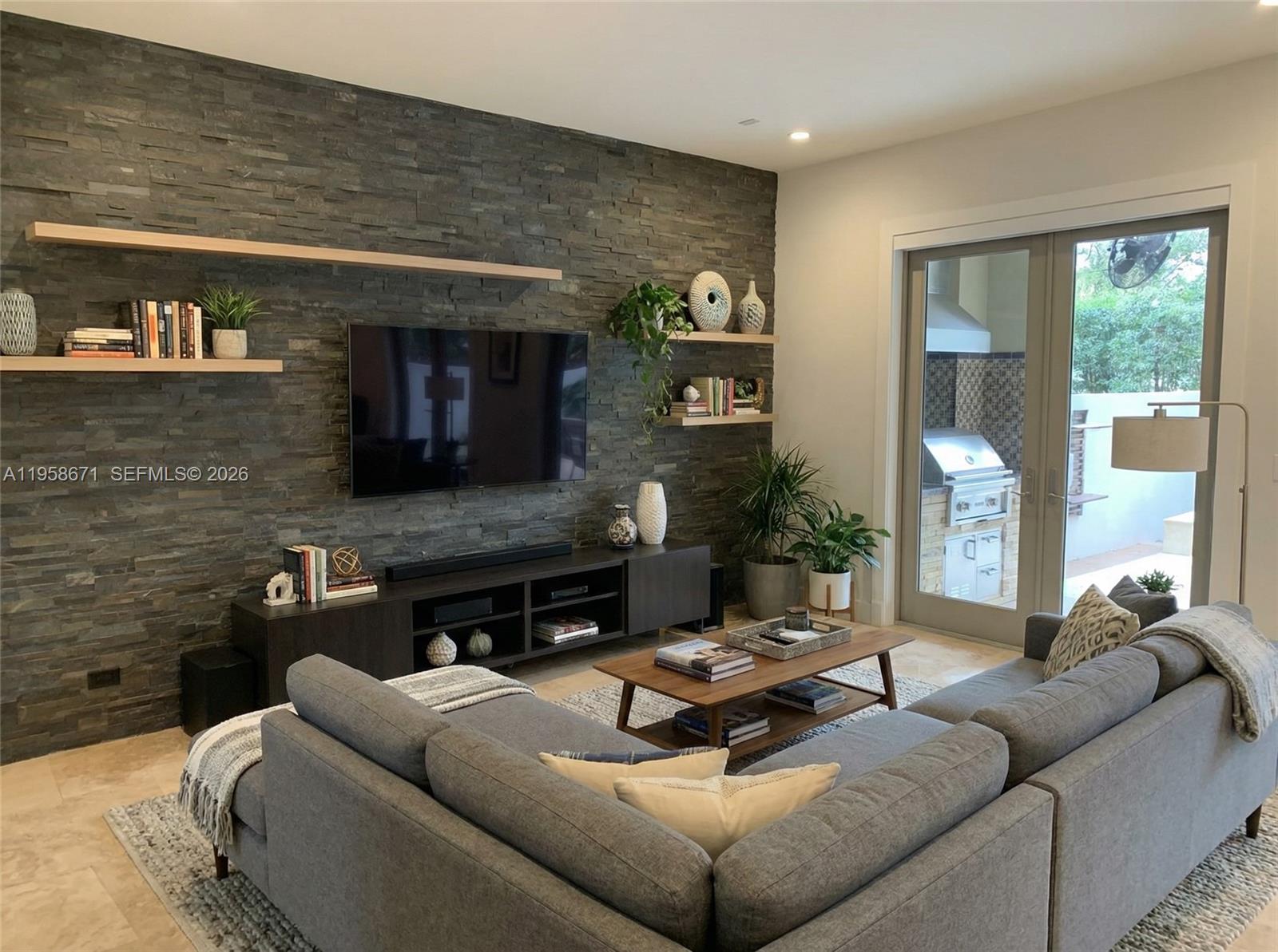 7560 Southwest 56th Court Miami, FL 33143 - Photo 15 of 30 a living room with fireplace furniture and a flat screen tv