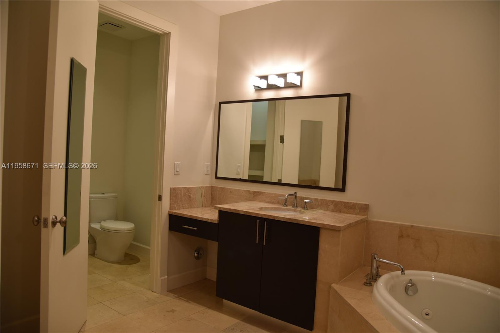 7560 Southwest 56th Court Miami, FL 33143 - Photo 20 of 30 a bathroom with a sink and a mirror