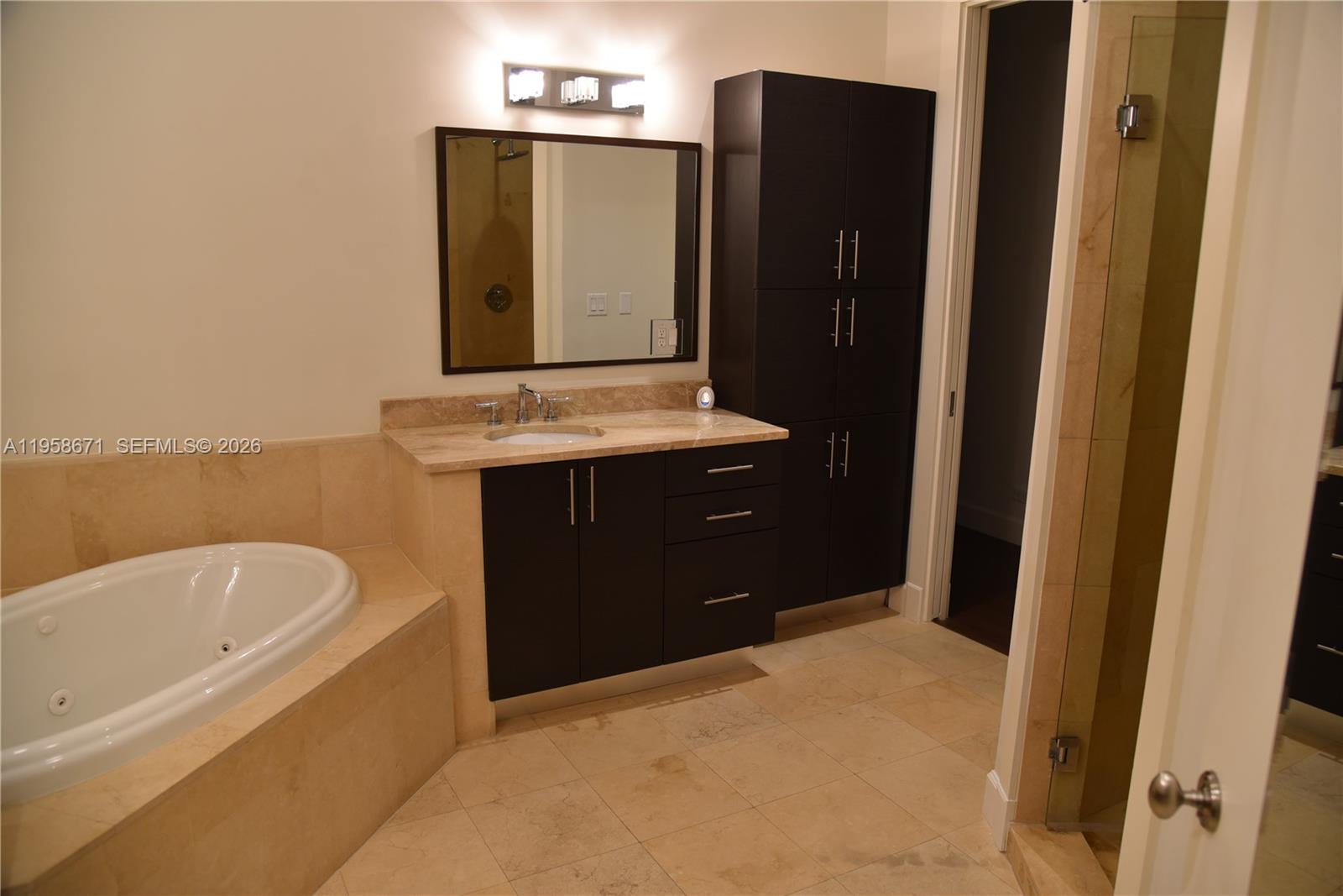 7560 Southwest 56th Court Miami, FL 33143 - Photo 21 of 30 a bathroom with a bathtub and a sink