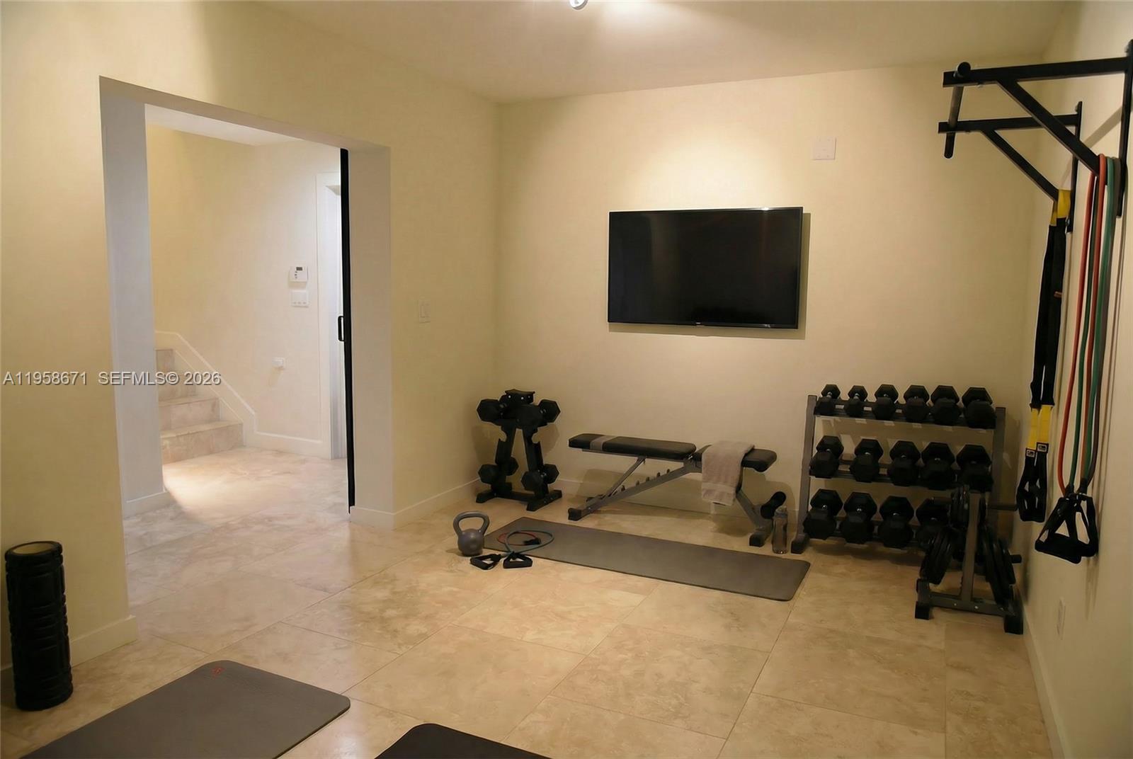 7560 Southwest 56th Court Miami, FL 33143 - Photo 25 of 30 a living room with furniture and a flat screen tv