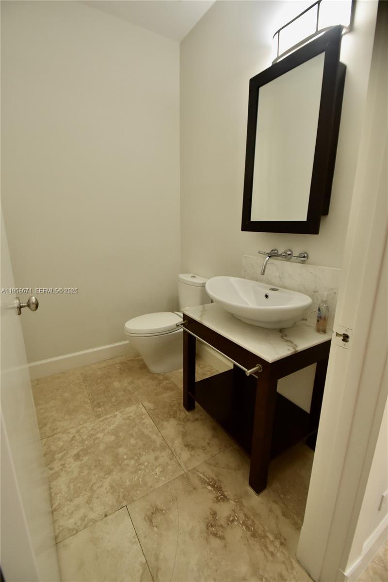 7560 Southwest 56th Court Miami, FL 33143 - Photo 10 of 30 a bathroom with a sink toilet and mirror