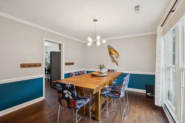a dining room with furniture and window