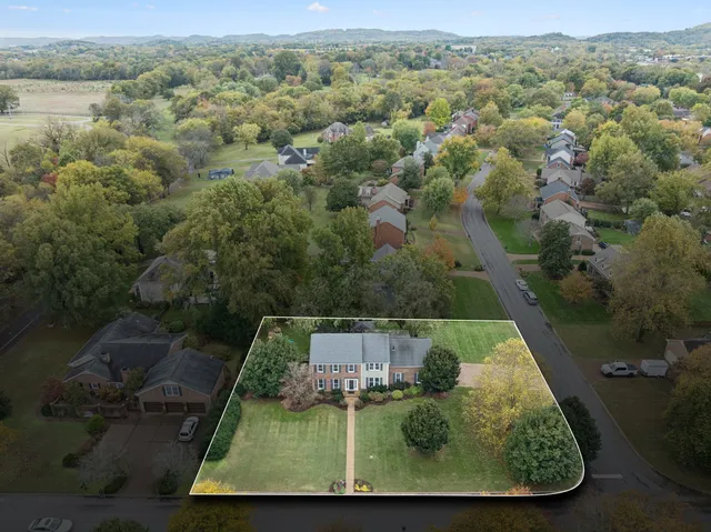 an aerial view of a house with a yard