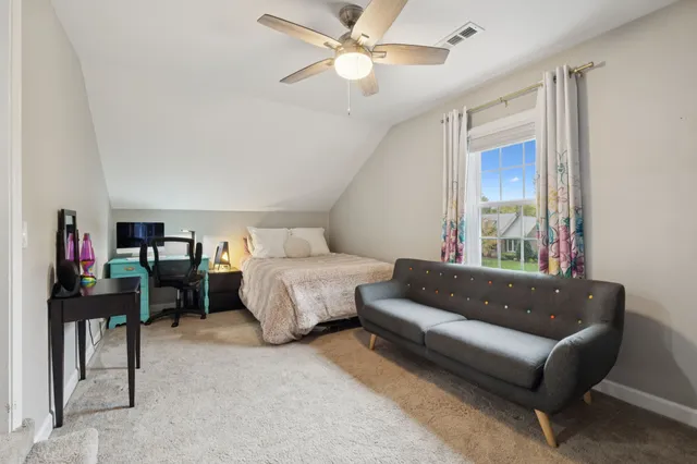 a view of a backyard with table and chairs and wooden fence