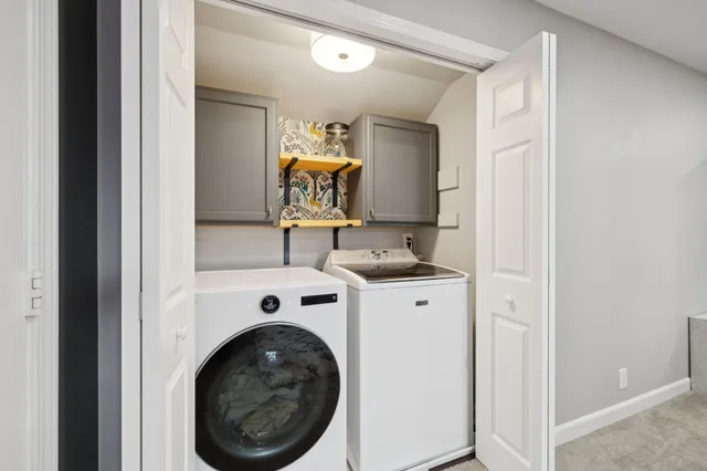 a view of a patio with couches chairs and a umbrella