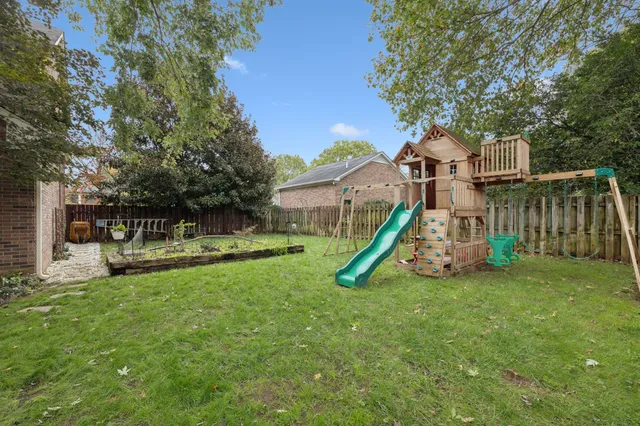 an aerial view of a houses with a yard