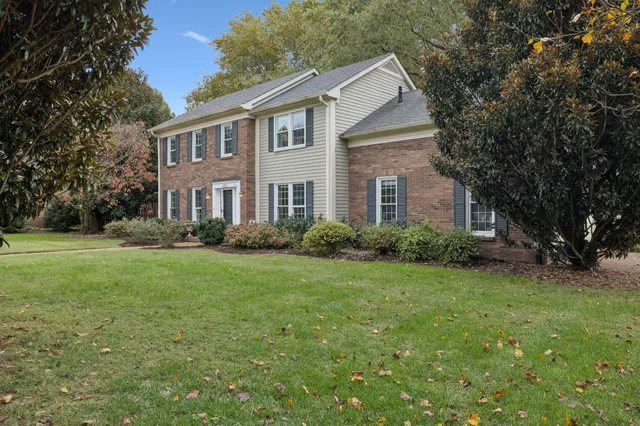 a front view of house with yard and green space