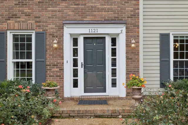 a front view of a building with potted plants
