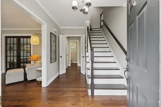 a view of an entryway with wooden floor and windows