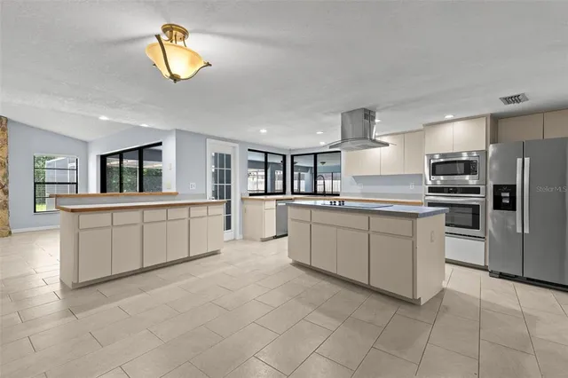 a kitchen with stainless steel appliances granite countertop a sink and a granite counter tops
