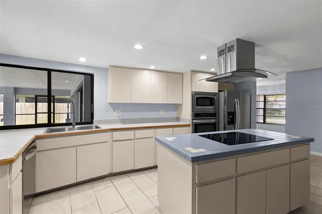 a kitchen with a sink and large window