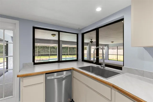 a kitchen with a table chairs refrigerator and wooden cabinets